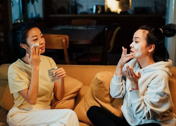 Women at home applying natural anti fungal treatments to their face