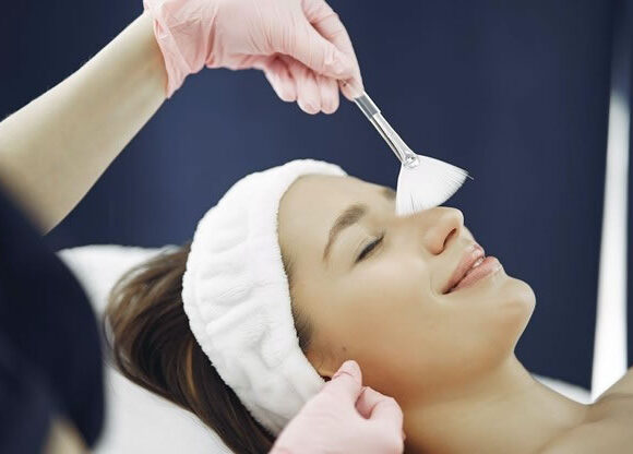The best skin care routine for fungal acne, young lady pampering her fungal acne-prone skin