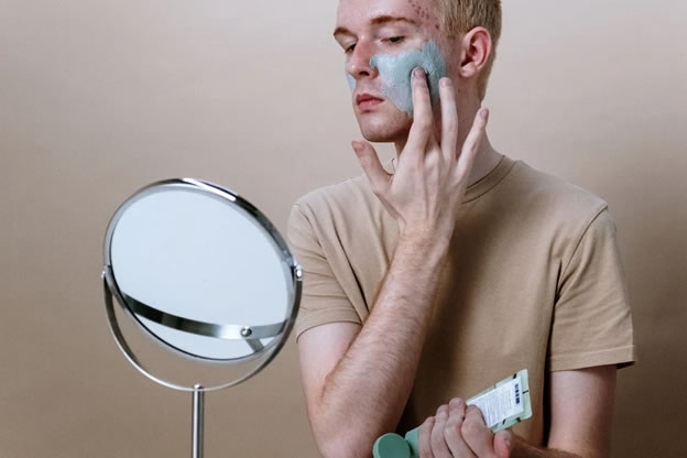 male using acne products for closed comedones