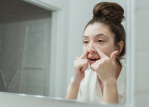 Young Woman Washing Her Face in the Bathroom